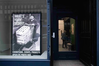 Shop front showing a poster asking &amp;#39;What&amp;#39;s your story?&amp;#39;