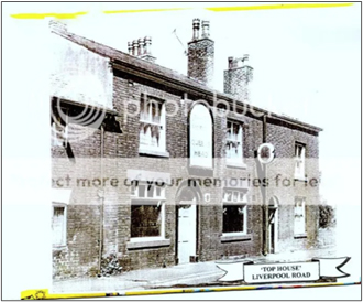 A black and white photograph, probably from the 29th Cenury showing the old Top House Pub.  A brick two-storey building with a central arched doorway and a large arched pub sign above with two windows on each floor either side.