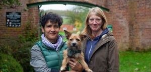Dr Sylvia Travershead of horticulture, poses with team leader Jo Parr and Sylvia&rsquo;s dog Florrie outside walled garden